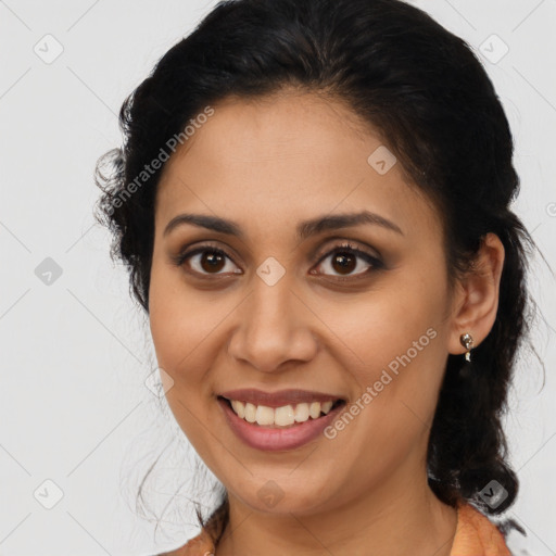 Joyful latino young-adult female with medium  brown hair and brown eyes