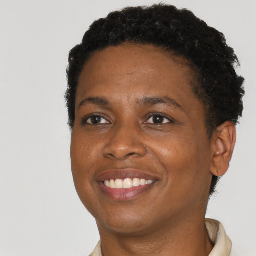 Joyful black young-adult female with short  black hair and brown eyes