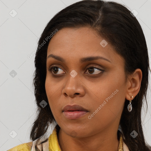 Joyful black young-adult female with long  brown hair and brown eyes