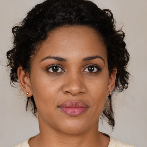 Joyful black young-adult female with medium  brown hair and brown eyes