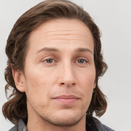 Joyful white adult male with medium  brown hair and brown eyes