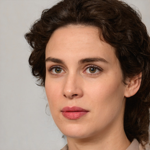 Joyful white young-adult female with medium  brown hair and green eyes