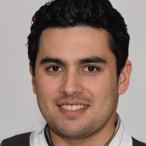 Joyful white young-adult male with short  black hair and brown eyes