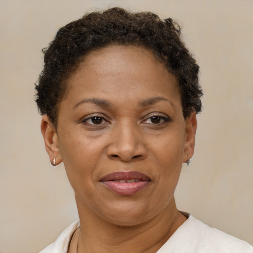 Joyful black adult female with short  brown hair and brown eyes