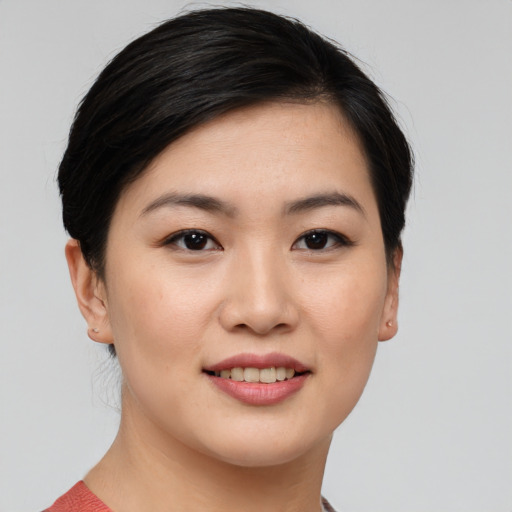 Joyful asian young-adult female with medium  brown hair and brown eyes