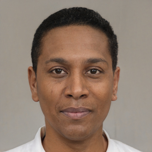 Joyful black young-adult male with short  black hair and brown eyes