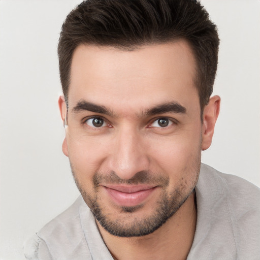 Joyful white young-adult male with short  brown hair and brown eyes