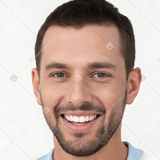 Joyful white young-adult male with short  brown hair and brown eyes