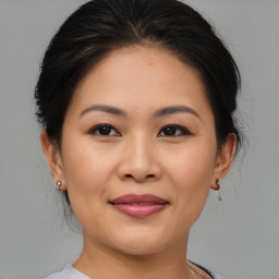 Joyful asian young-adult female with medium  brown hair and brown eyes