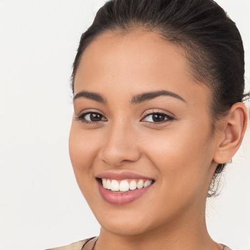 Joyful white young-adult female with long  brown hair and brown eyes