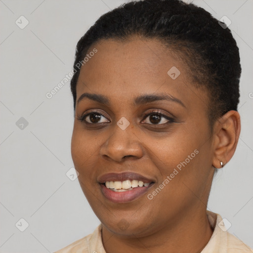 Joyful black young-adult female with short  brown hair and brown eyes