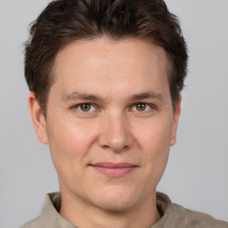 Joyful white adult male with short  brown hair and grey eyes