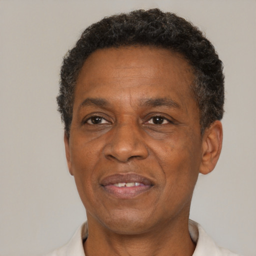 Joyful black adult male with short  brown hair and brown eyes