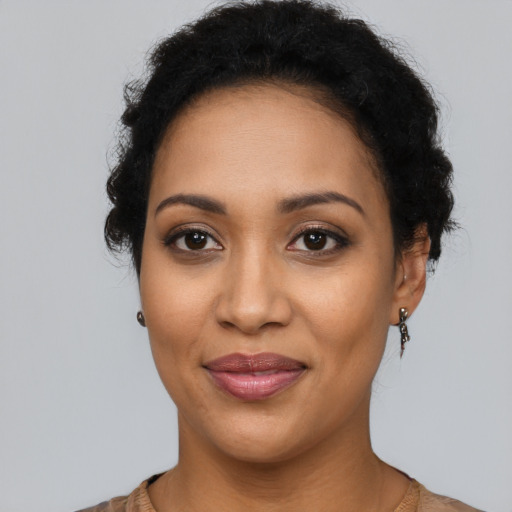 Joyful latino young-adult female with short  black hair and brown eyes