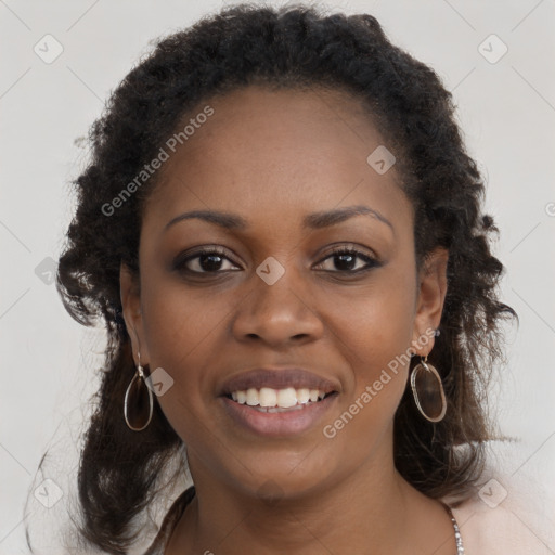 Joyful black young-adult female with long  brown hair and brown eyes