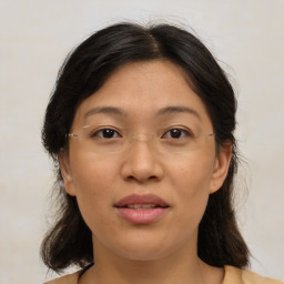 Joyful asian adult female with medium  brown hair and brown eyes