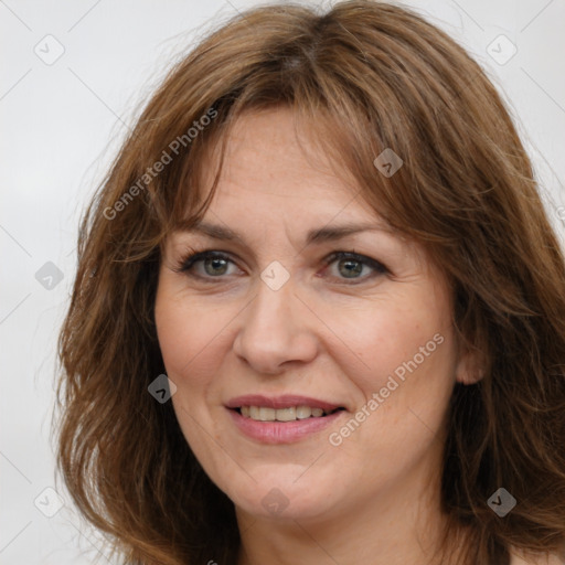 Joyful white adult female with long  brown hair and brown eyes