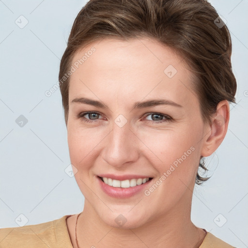 Joyful white young-adult female with short  brown hair and grey eyes