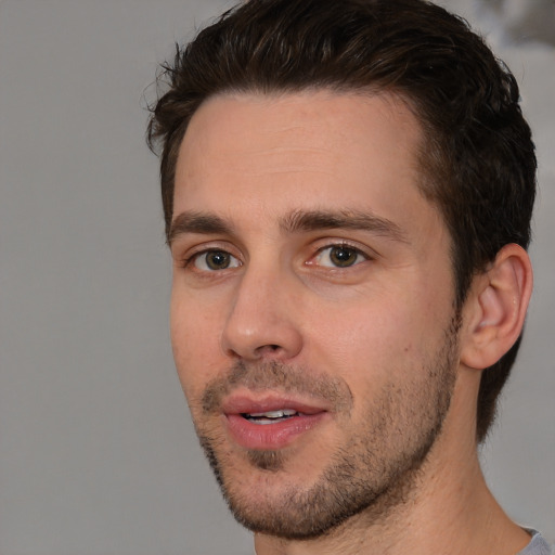 Joyful white young-adult male with short  brown hair and brown eyes