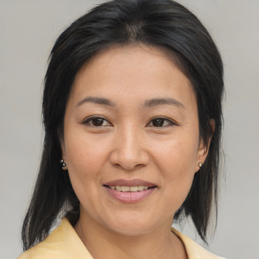 Joyful asian young-adult female with medium  brown hair and brown eyes