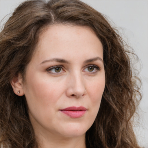 Joyful white young-adult female with long  brown hair and green eyes