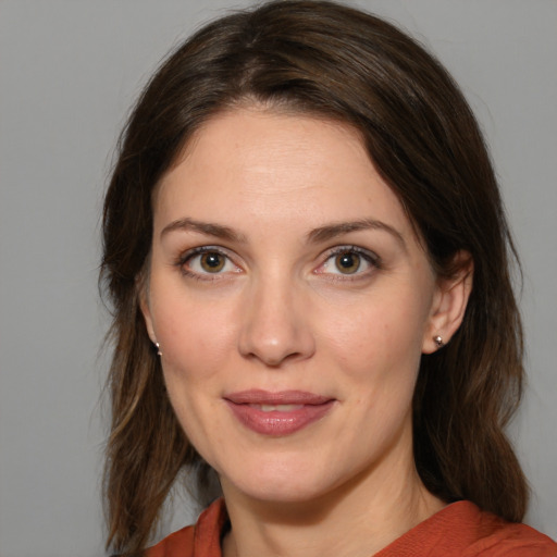 Joyful white adult female with medium  brown hair and brown eyes