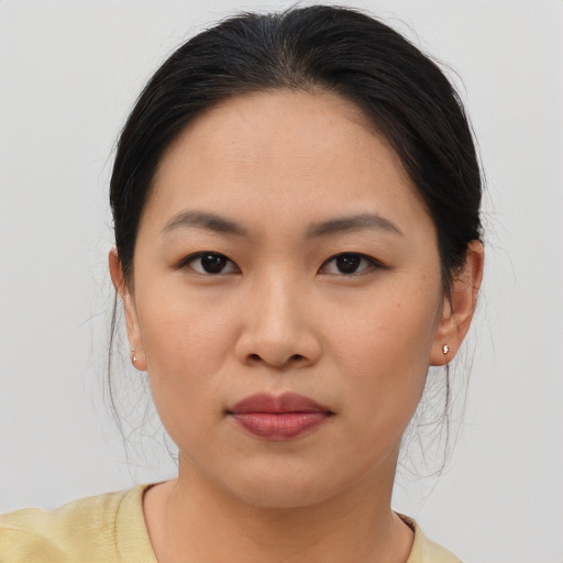 Joyful asian young-adult female with medium  brown hair and brown eyes