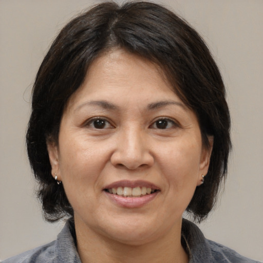 Joyful white adult female with medium  brown hair and brown eyes