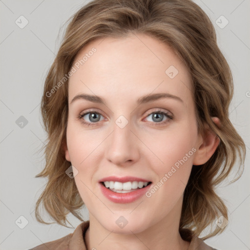 Joyful white young-adult female with medium  brown hair and blue eyes