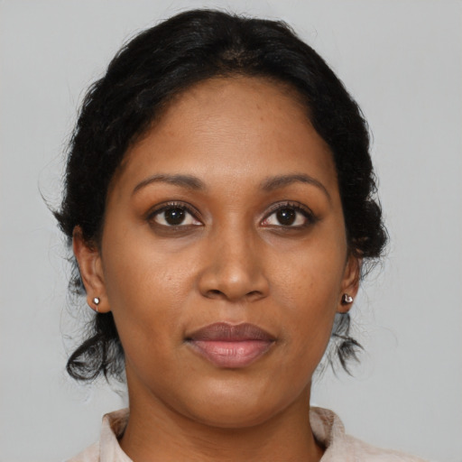 Joyful black young-adult female with medium  brown hair and brown eyes