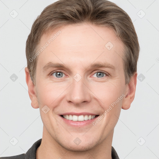 Joyful white young-adult male with short  brown hair and grey eyes