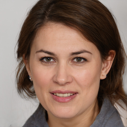 Joyful white adult female with medium  brown hair and brown eyes