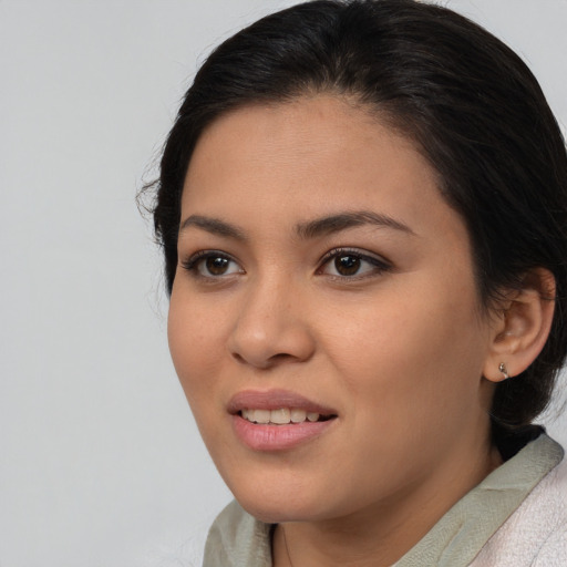 Joyful asian young-adult female with medium  brown hair and brown eyes