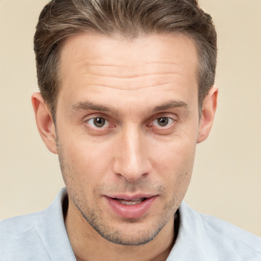 Joyful white adult male with short  brown hair and brown eyes