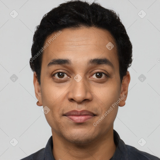 Joyful latino young-adult male with short  black hair and brown eyes