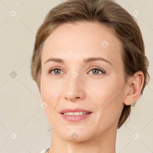 Joyful white young-adult female with medium  brown hair and green eyes