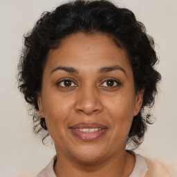 Joyful latino adult female with short  brown hair and brown eyes