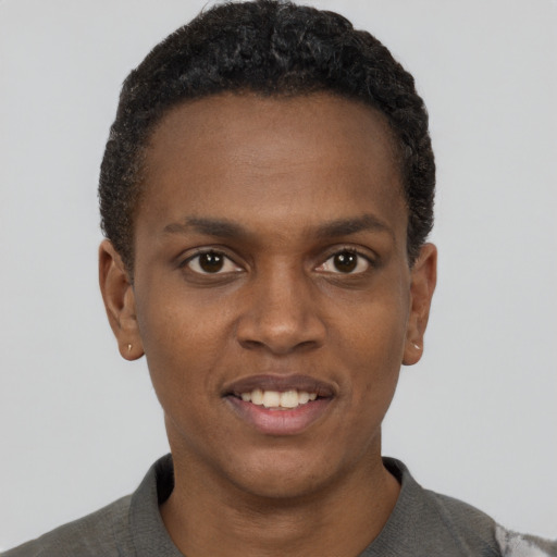 Joyful black young-adult male with short  black hair and brown eyes