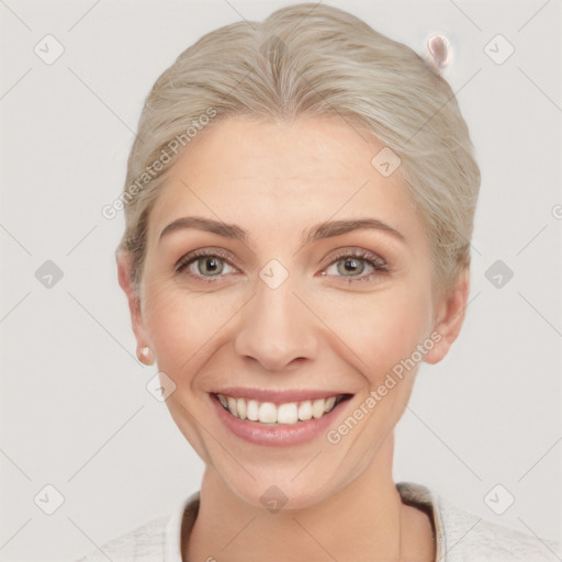 Joyful white young-adult female with short  brown hair and blue eyes