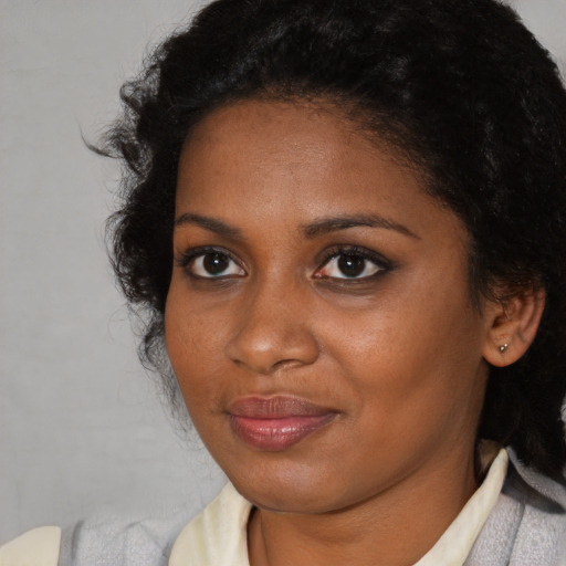 Joyful black young-adult female with medium  brown hair and brown eyes