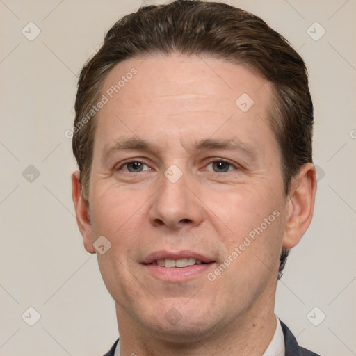 Joyful white adult male with short  brown hair and grey eyes