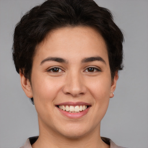 Joyful white young-adult female with short  brown hair and brown eyes