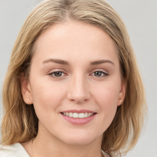 Joyful white young-adult female with medium  brown hair and blue eyes