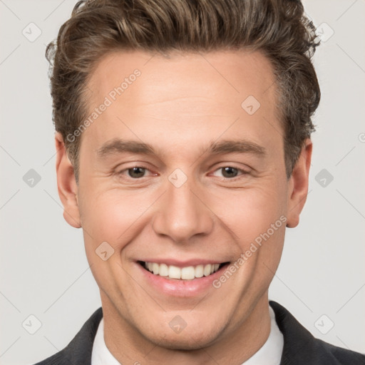 Joyful white adult male with short  brown hair and brown eyes