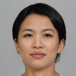 Joyful asian young-adult female with medium  black hair and brown eyes