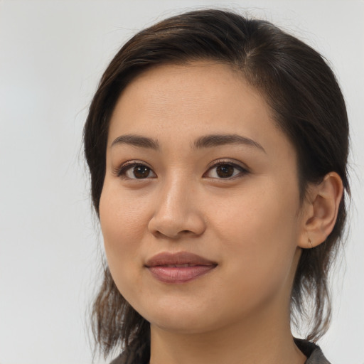 Joyful latino young-adult female with medium  brown hair and brown eyes