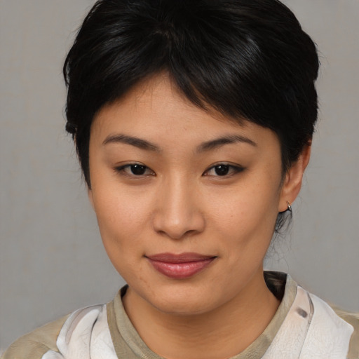 Joyful asian young-adult female with medium  brown hair and brown eyes