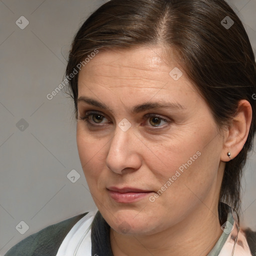 Joyful white adult female with medium  brown hair and brown eyes