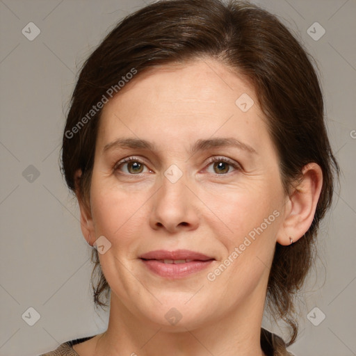 Joyful white adult female with medium  brown hair and green eyes