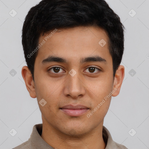 Joyful latino young-adult male with short  brown hair and brown eyes
